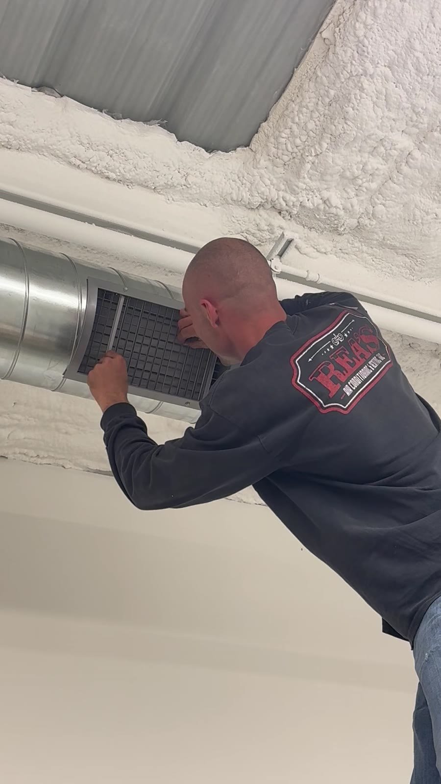 Rea's HVAC technician adjusting flush-mounted register on completed spiral duct run