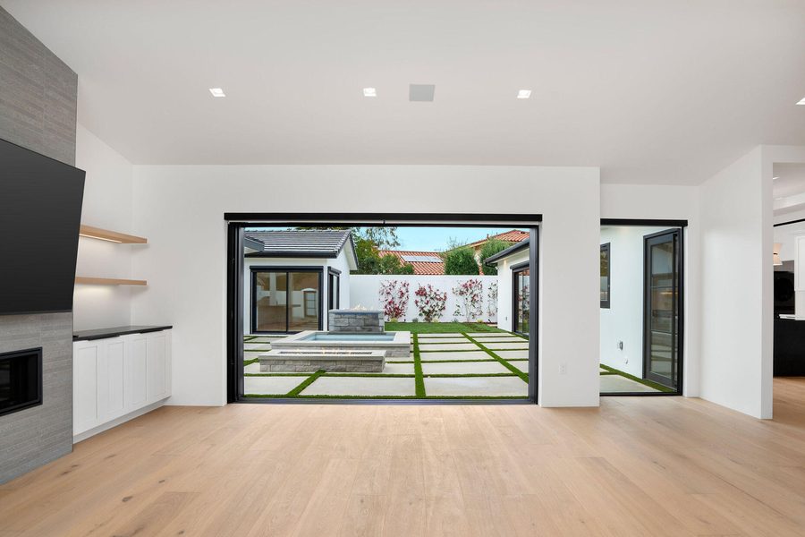 Open-concept living room with flush linear ceiling vents